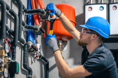 Plumbing professional inspecting water line connections